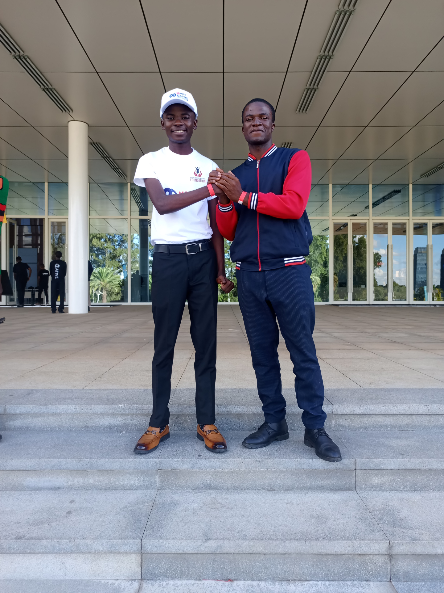 Two FORGE delegates at a conference venue entrance